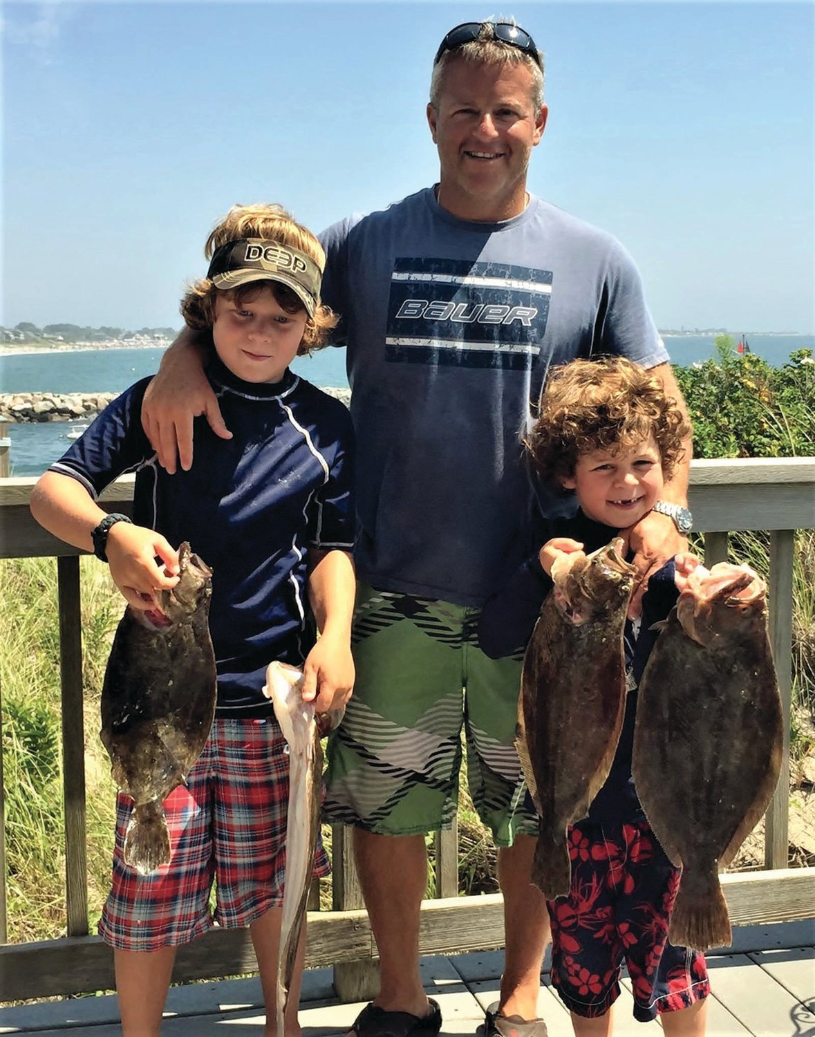 BLUEFIN MAGIC: In 2016 Jude (nine) and Rowan (six) with father Jimmy Monti of Warwick with summer flounder. 